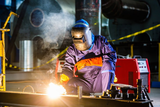 Welder working in industrial factory - Photo, Image