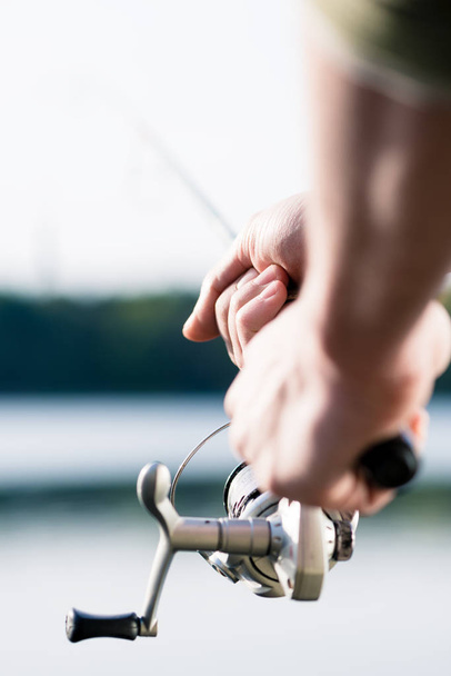 Close-up of Fisherman with fishing rod in hand - Фото, зображення