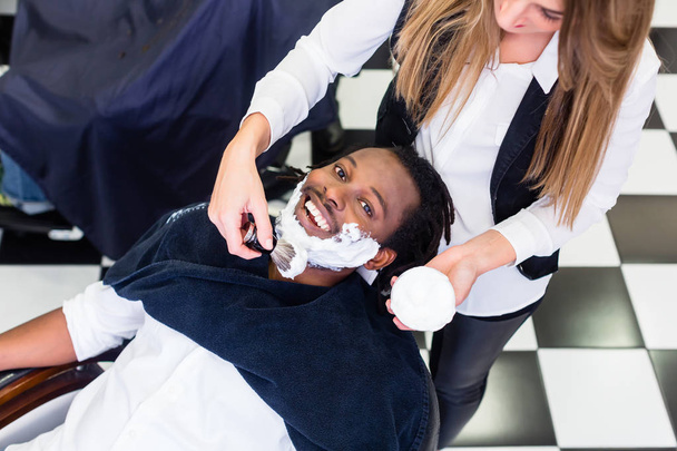 Cliente na barbearia com creme de barbear
 - Foto, Imagem