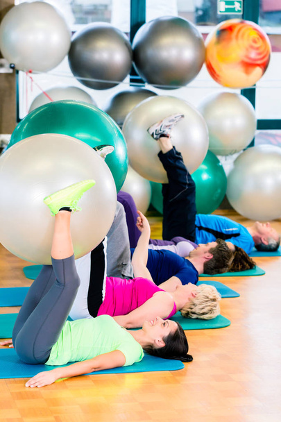 Young and senior people exercising with ball in gym - Zdjęcie, obraz