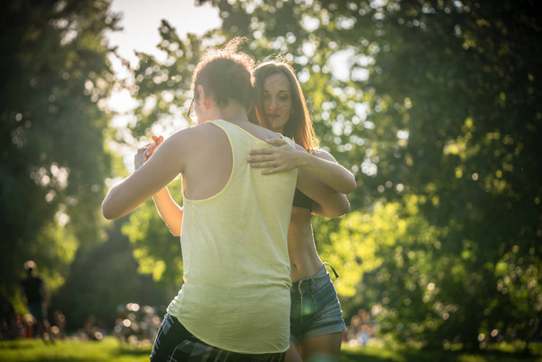 Couple dancing bachata in park  - Foto, afbeelding