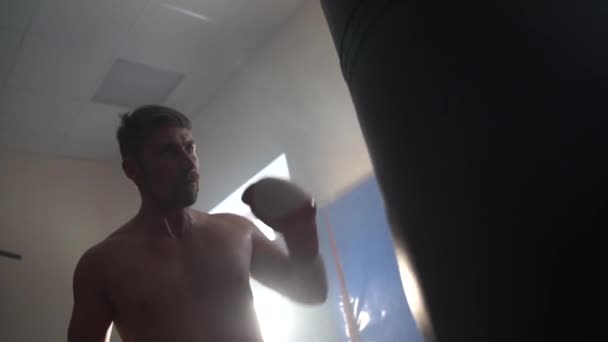 Handsome man boxing with red boxing gloves - Footage, Video