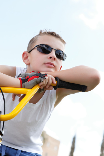 Boy with glasses on a bicycle - Фото, зображення