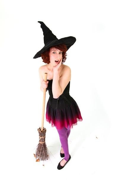Surprised halloween witch with a broom isolated on a white backg - Foto, Imagem