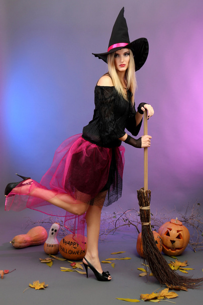 Halloween witch with broom on color background - Foto, Imagen
