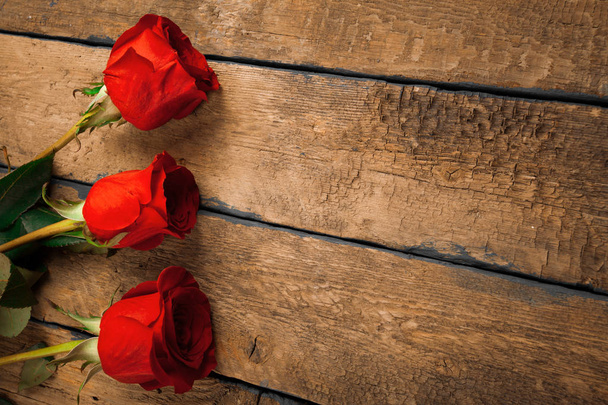 Roses on old wooden board, Valentines Day background - Photo, image