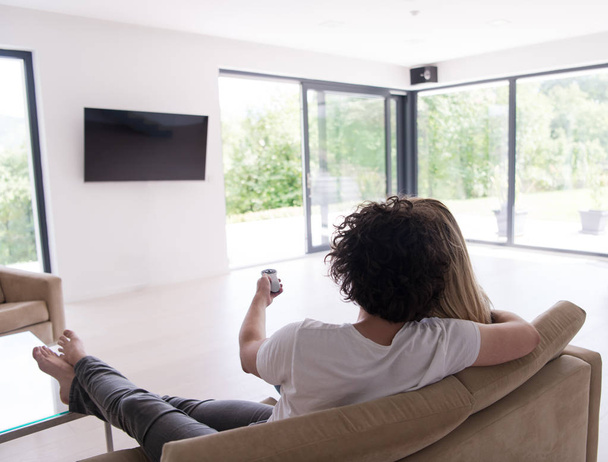Rear view of couple watching television - Photo, Image
