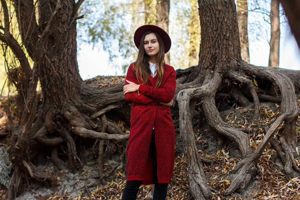 cute girl in red cardigan and hat in autumn - Photo, image
