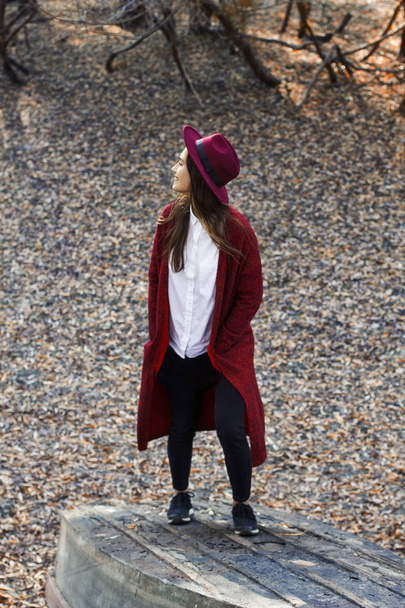 cute girl in red cardigan and hat in autumn - 写真・画像