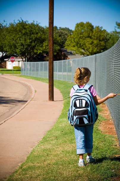 Young girl walking to school on first day of school - 写真・画像