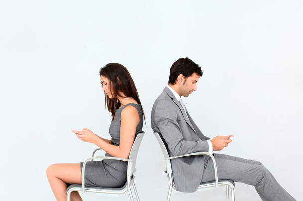 Business sitting in chairs with mobile phone - Foto, Bild