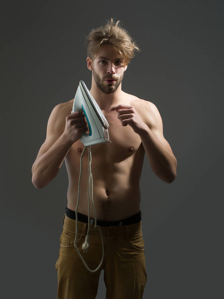 Topless man with iron - Zdjęcie, obraz