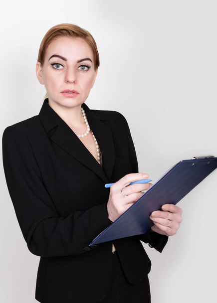 Attractive energetic business woman holding pad for writing and takes notes - Foto, immagini
