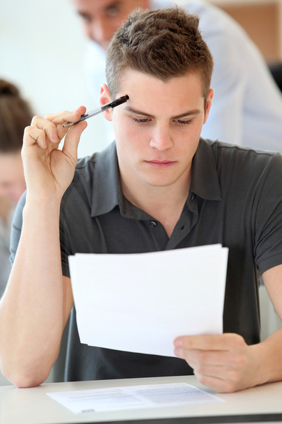 Portrait of student boy doing written exam - Valokuva, kuva