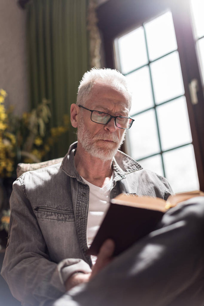 Man reading a book, hard light effect - Фото, изображение