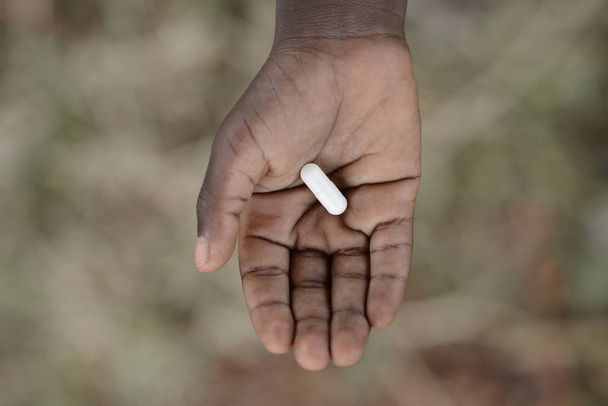 African child hand holding medicine - Foto, imagen