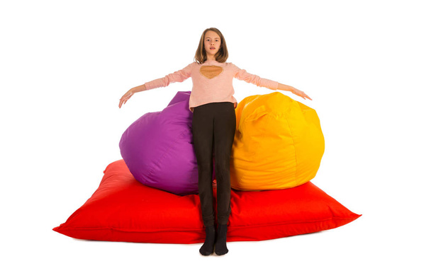 Girl standing near beanbag chairs and beanbag sofa - Фото, зображення