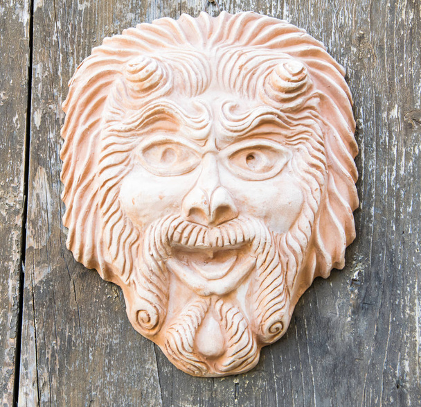 Earthenware Mask on wooden wall. - 写真・画像