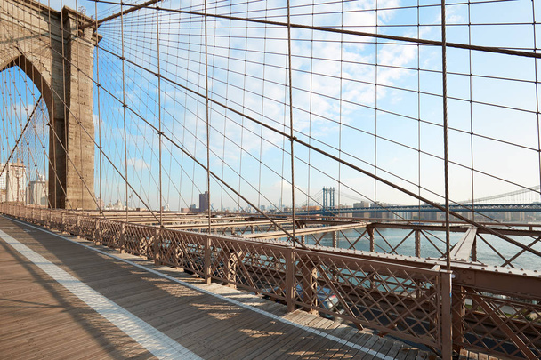Empty Brooklyn Bridge footpath in the morning sunlight, New York - Фото, изображение