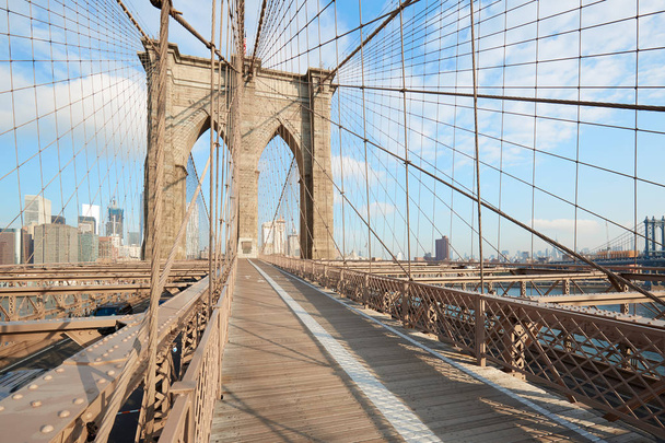Empty Brooklyn Bridge view in the morning sunlight in New York - Photo, image