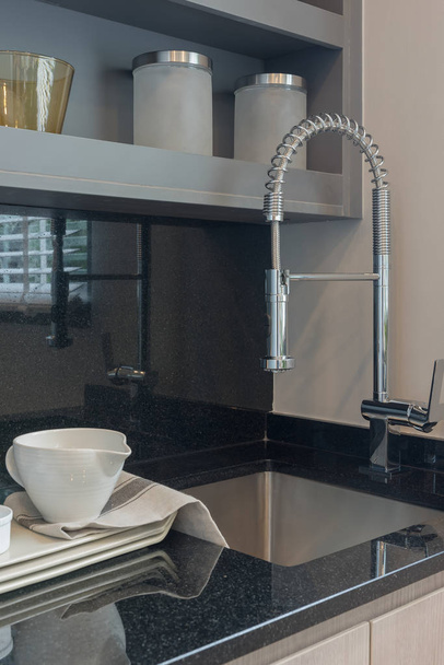 modern kitchen room with sink on top granite counter - 写真・画像