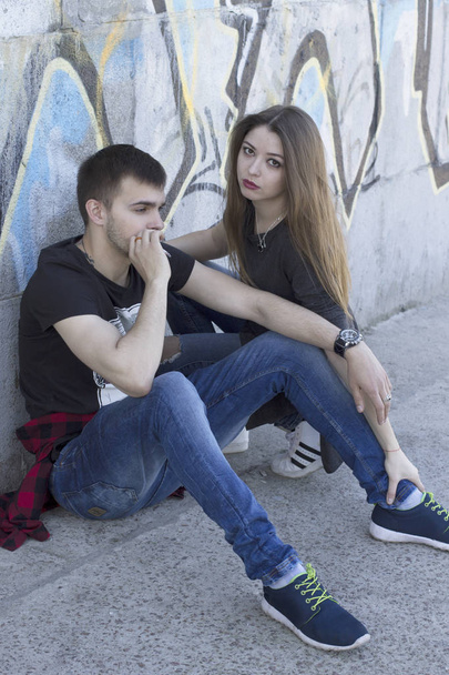 Young guy smokes near his girlfriend. Passive smoking - Foto, afbeelding