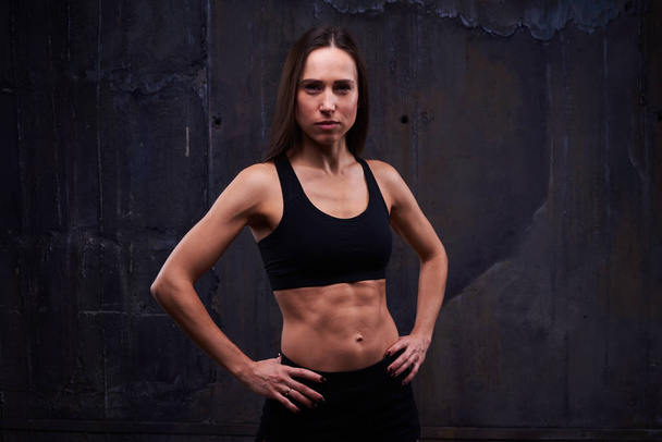 Young sporty female accomplished functional training in the dark - Zdjęcie, obraz