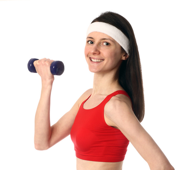 Happy young woman exercising with a dumbbell - Фото, изображение