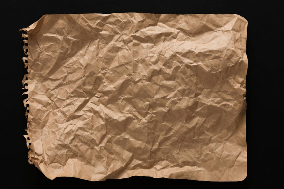 old paper sheet isolated on black background - Foto, afbeelding