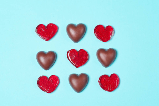 Chocolate candies and red lollipops - Zdjęcie, obraz