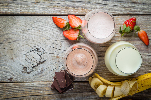 Selection of flavoured milk - strawberry, chocolate, banana - Фото, изображение