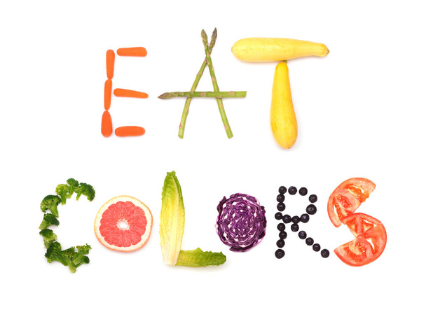 Eat colors - text spelled out in colorful plant foods; concept of healthy eating, on white - 写真・画像