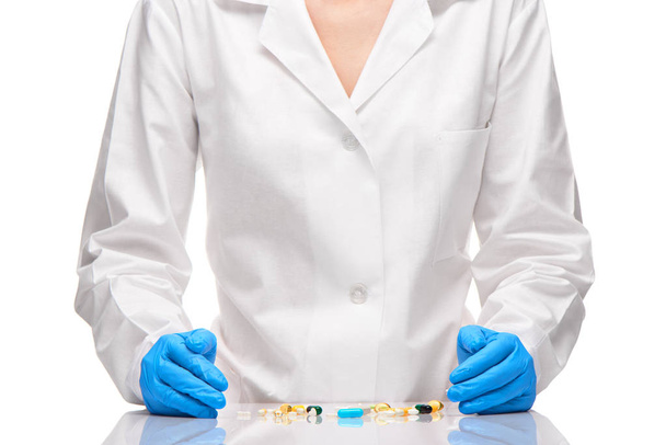 Tablets and capsules in front of doctor in white gown  - Foto, afbeelding