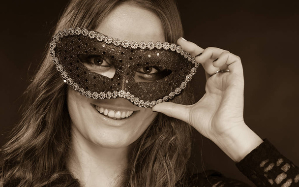 Closeup woman face with carnival mask on dark - Foto, immagini