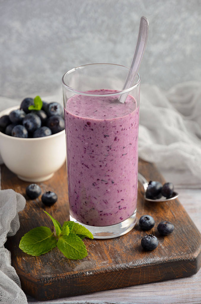 Blueberry and banana smoothie with oatmeal on the rustic wooden table - Foto, imagen