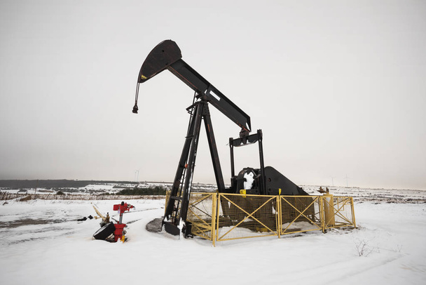 Крупный план нефтяного насоса в зимний сезон
. - Фото, изображение