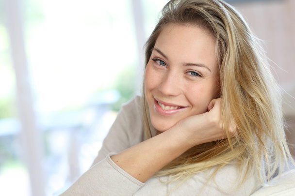 Attractive young blond woman relaxing in sofa - Fotografie, Obrázek