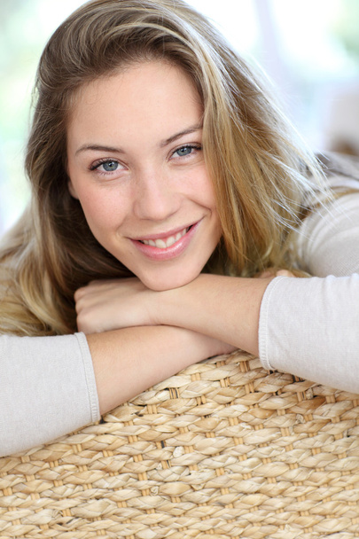 Attractive young blond woman relaxing in sofa - Фото, зображення