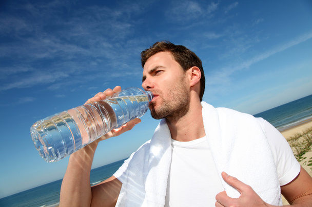 Portrait of jogger drinking water from bottle - Φωτογραφία, εικόνα