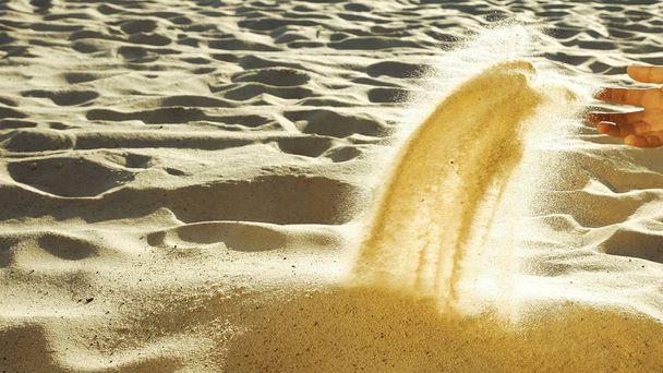 Человек, просеивающий песок рукой
 - Фото, изображение