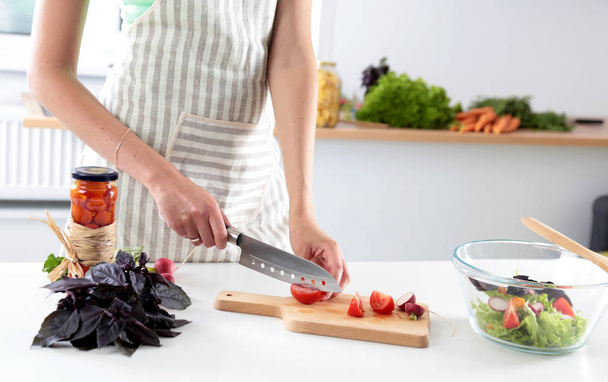 Fresh vegetables on the cutting board are falling in the pot, concept of cooking - Photo, Image