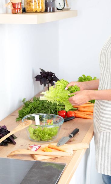 Fresh vegetables on the cutting board are falling in the pot, concept of cooking - 写真・画像