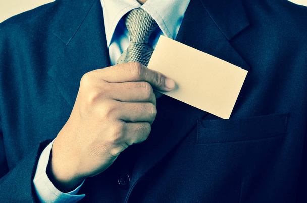 Businessman extracting a business card from a pocket - Φωτογραφία, εικόνα