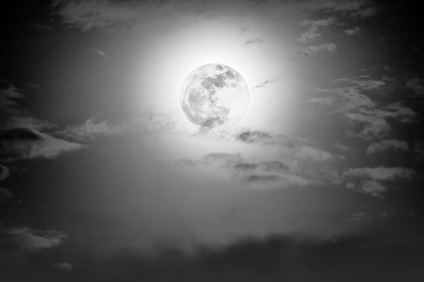 Nighttime sky with clouds and bright full moon with shiny.   - Photo, Image