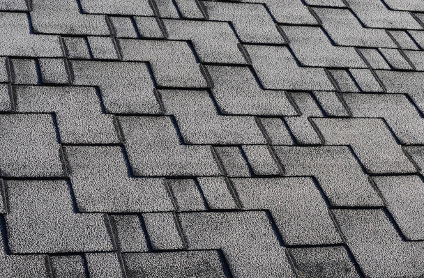 Close up view on Asphalt Roofing Shingles Background. Roof Shingles - Roofing. Roof shingles covered with frost - Photo, Image