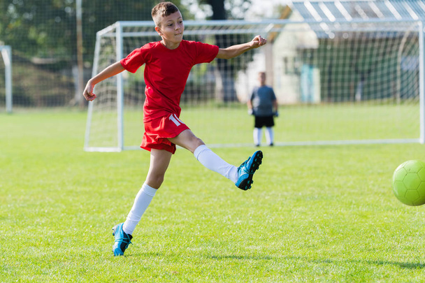 Boy kicking soccer ball  - Valokuva, kuva
