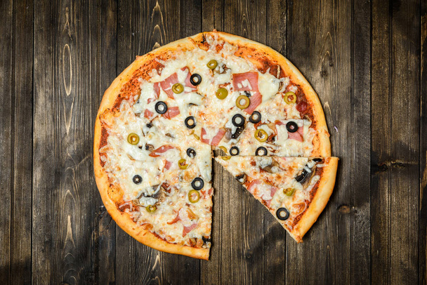 Top view of Italian rustic PIZZA on wooden table background - Фото, зображення