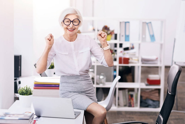 Joyful aged business lady expressing happiness in the office - Zdjęcie, obraz