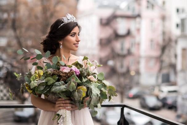 bride with a bouquet of flowers on the balcony - Fotoğraf, Görsel