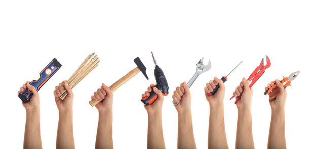 Hands holding tools on white background - 写真・画像